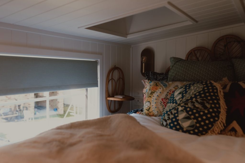 a-cozy-bedroom-with-a-bed-window-and-skylight-rg-ptyg9pss