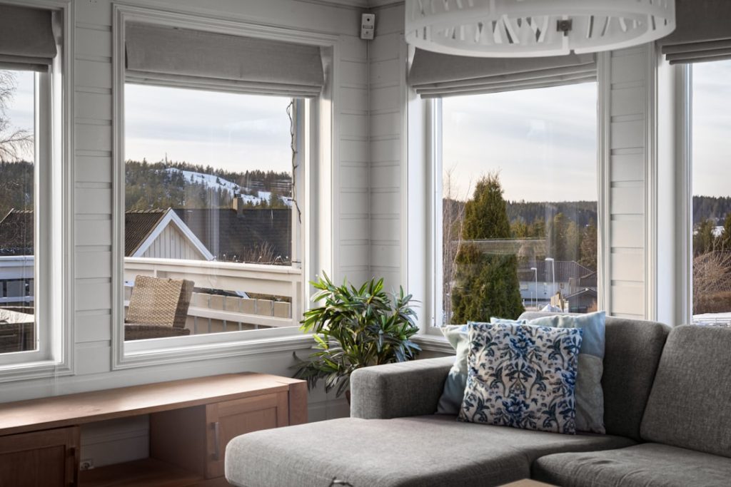 a-living-room-filled-with-furniture-and-lots-of-windows-7a8gvnqnu1m